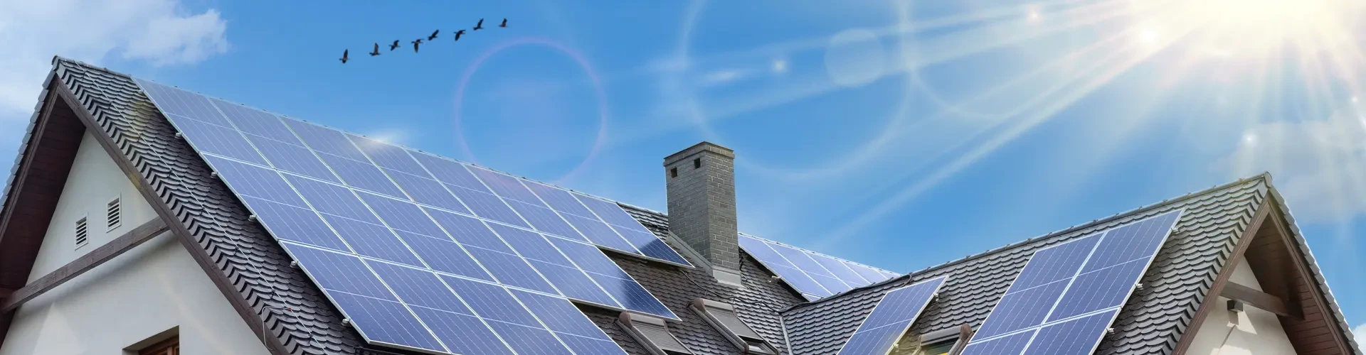 Solar panels on residential rooftop with sunrays, SOLRITE Energy